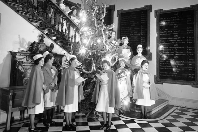 Nurses singing Christmas carols around the Christmas tree at the Edinburgh Royal Infirmary in 1965.