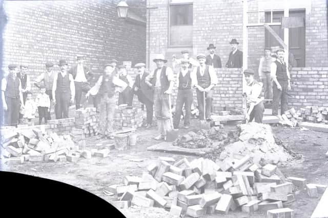 This damaged glass slide from the Heritage Doncaster collection shows a local workforce, possibly including a person of colour