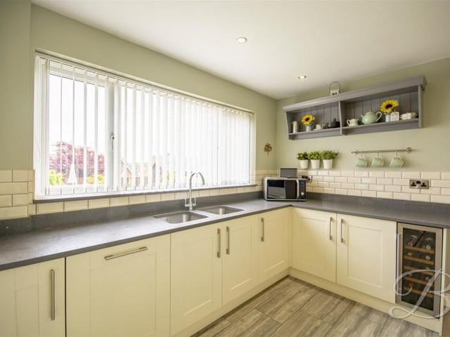 It has a gas hob with extractor over, side by side electric oven and integrated dishwasher and wine cooler.