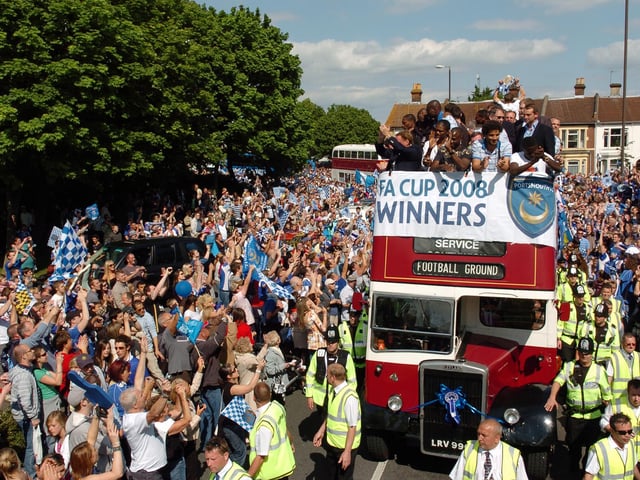 Fans waving and cheering the Pompey players. Picture: Malcolm Wells 082235-99