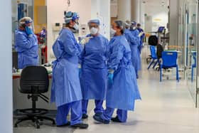 Health workers wearing full personal protective equipment (PPE) on the intensive care unit (ICU) at Whiston Hospital in Merseyside as they continue deal with the increasing number of coronavirus patients.