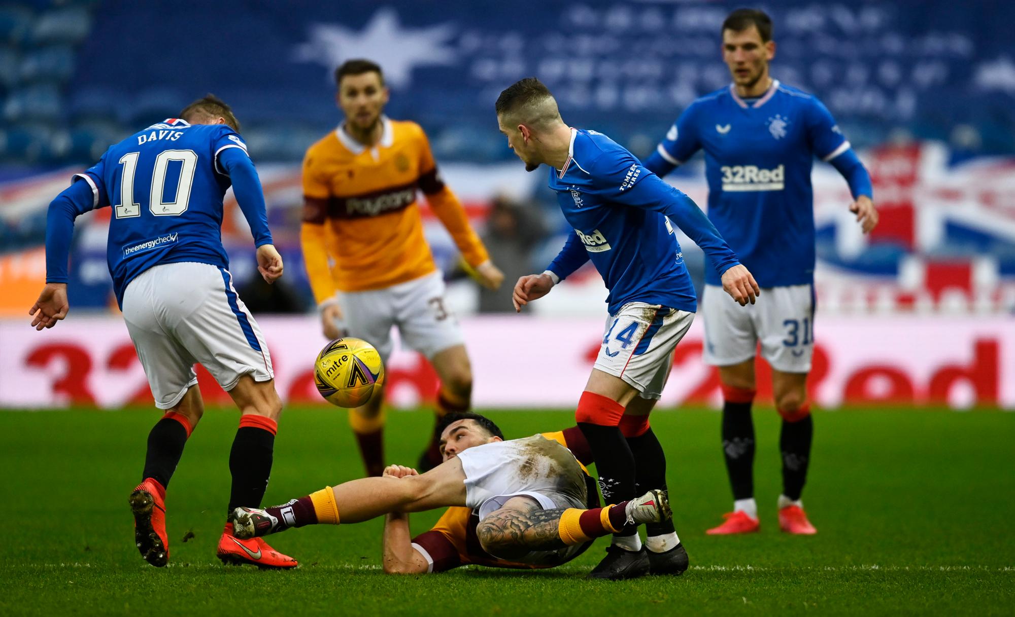 Ryan Kent and Steven Davis compete for possession. Picture; SNS