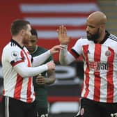 Sheffield United's David McGoldrick celebrates scoring their first goal with John Fleck during the English Premier League soccer match between Sheffield United and Tottenham Hotspur at the Bramall Lane: Mike Egerton/Pool via AP
