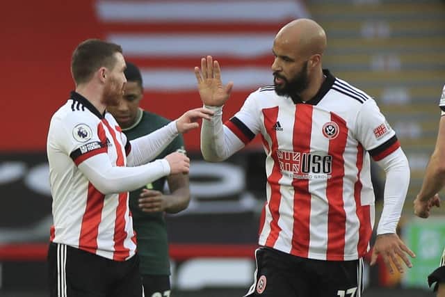 Sheffield United's David McGoldrick celebrates scoring their first goal with John Fleck during the English Premier League soccer match between Sheffield United and Tottenham Hotspur at the Bramall Lane: Mike Egerton/Pool via AP