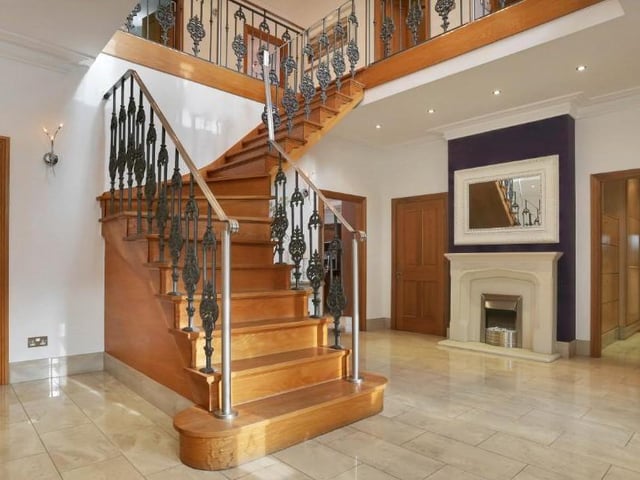 The property seeps grandeur from the outset, with a fabulous porch opening into this magnificent reception hallway. It includes a grand oak staircase of bespoke design, a porcelain tiled floor, attractive feature-fireplace, ceiling spotlights and an under-stairs storage cupboard.