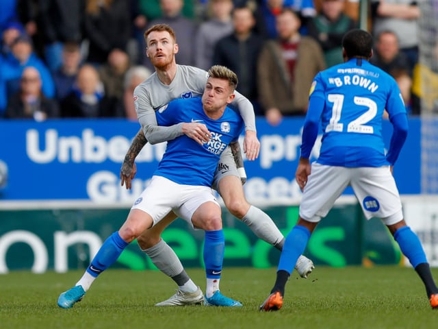 Tom Naylor battles with Peterborough United midfielder Sammie Szmodics