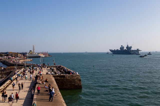 Socially-distanced crowds watch as HMS Queen Elizabeth leaves Portsmouth. View from Square Tower, Old Portsmouth. Picture: Habibur Rahman