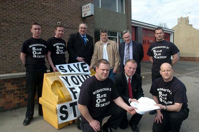 Pictured outside the Mosborough Fire Station, which is under threat of closure, where a petition against the plans was handed over to MP Clive Betts. Seen is Mr Betts as he receives the petition from fire fighters, left to right: Ian Thompson and Lee Rhodes. In the background are fire fighters  Daren Kenny, Paul Bell, Coun Chris Rosling-Josephs, Coun Bryan Lodge, Coun Mike Pye, and firefighter Adrian Thacker, March 25, 2005