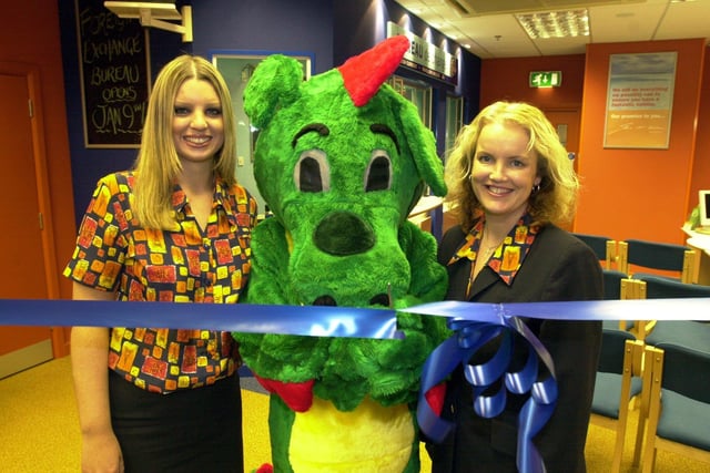 Snappy the dragon performs the opening ceremony at the new revamped Lunn Poly shop at Meadowhal in 2001 with Amy Jenkins who works at the shop and deputy manger Kathie Taylor, right