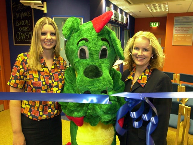 Snappy the dragon performs the opening ceremony at the new revamped Lunn Poly shop at Meadowhal in 2001 with Amy Jenkins who works at the shop and deputy manger Kathie Taylor, right