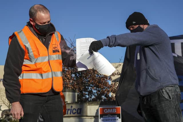British Gas workers burn contracts outside the headquarters of Centrica