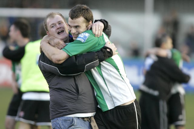 A fan and player embrace after the final whistle.