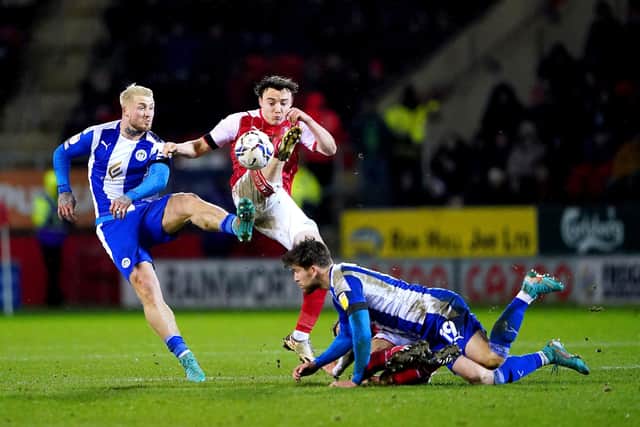 Wigan Athletic's Stephen Humphrys (left) and Rotherham United's Ollie Rathbone battle for the ball during the Sky Bet League One match at the AESSEAL New York Stadium. Picture: Zac Goodwin/PA Wire.