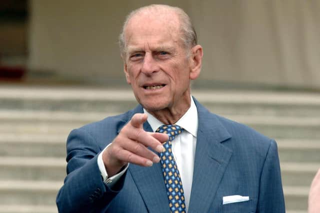 Duke of Edinburgh pointing the way as he and Queen Elizabeth II met guests at a garden party to mark 50 years of his award scheme at Buckingham Palace - PA