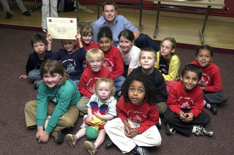 Pulp's drummer Nick Banks, rear, presenting a language prize to pupils at Broomhall Nursery on July 8, 2002