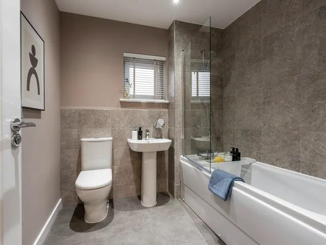The family bathroom comes equipped with a shower/bath, toilet, sink.