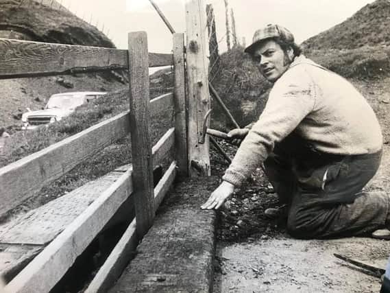 Our picture shows 28-year-old Bill Randles a National Trust warden for the High Peak repairing a fence in July 1974