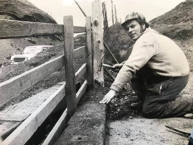 Our picture shows 28-year-old Bill Randles a National Trust warden for the High Peak repairing a fence in July 1974