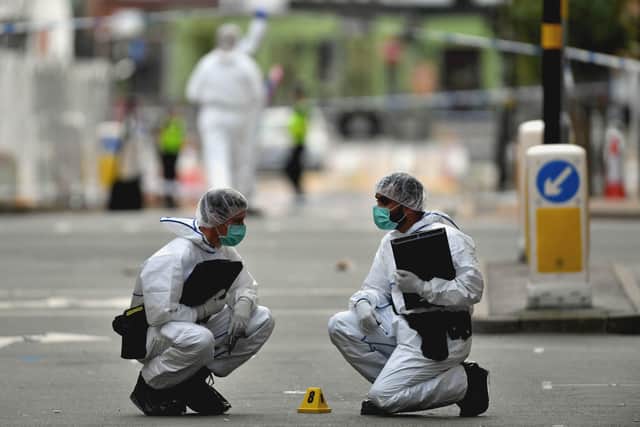 Two police forensics officers at work in Hurst Street, in Birmingham after a number of people were stabbed in the city centre. Photo: Jacob King/PA Wire