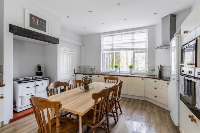 Opposite the drawing room at Oakerthorpe Manor is this pleasant kitchen and breakfast room. It features integrated appliances, including ample storage, wood-effect flooring, spotlights and a Rayburn Royal range cooker.