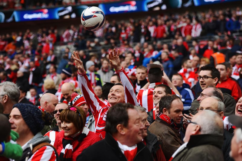 A happy Sunderland fan throws the ball back prior to kick-off.