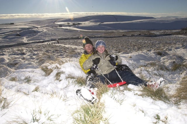 Sarah Bullock, 12, and her father Glyn Bullock sledging on the Mam Tor in the High Peak  in December 2001.