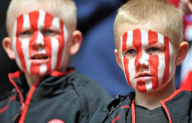 Young Sheffield United fans watch their side take on Crystal Palace in the Championship at Selhurst Park in May 2009.  (Photo credit should read Leon Neal/AFP via Getty Images)