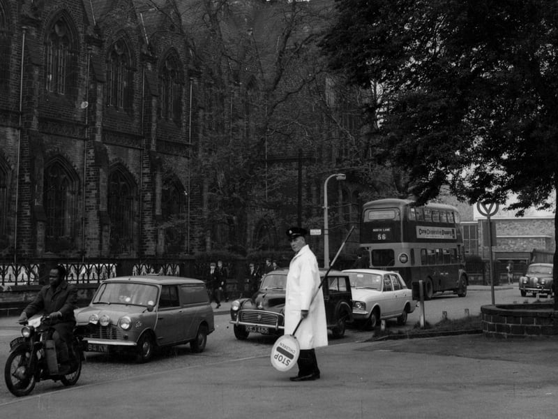 A lollipop man ready to help pupils cross outside Leeds Grammar School in June 1967