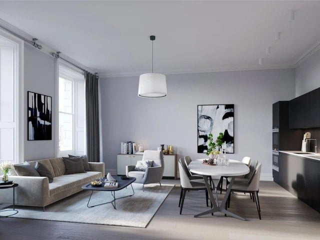 With natural light flooding through large sash-and-casement windows, this open-plan living/ dining/kitchen area offers lovely views across Edinburgh (photo: Rettie).