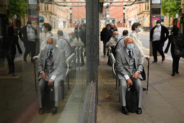 Shopper wear face masks in the city centre of Sheffield, south Yorkshire on July 24, 2020, as lockdown restrictions continue to be eased during the novel coronavirus COVID-19 pandemic. - Face coverings are now compulsory for customers in shops in England. (Photo by Oli SCARFF / AFP) (Photo by OLI SCARFF/AFP via Getty Images)
