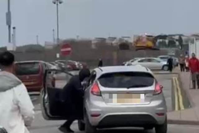 Pictures show the dramatic moment when a suspected car thief fell out of a ‘getaway vehicle’ as his gang fled after being spotted. This shows him trying to get into the car
