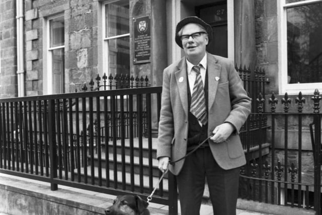 Scottish historian, poet and songwriter Hamish Henderson with his dog Sandy outside the School of Scottish Studies in Edinburgh, March 1982.
