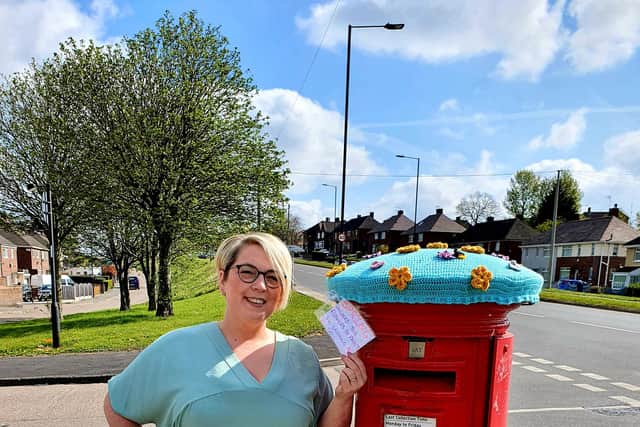 Louise Green from Sheffield is pictured with her postbox topper.