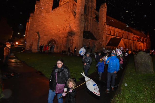 The Wintertide lantern parade passes through the grounds of St. Hilda's Church in 2015.