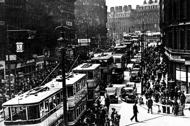 A rammed Fargate in 1937. Trams, buses, cars and lots of people.