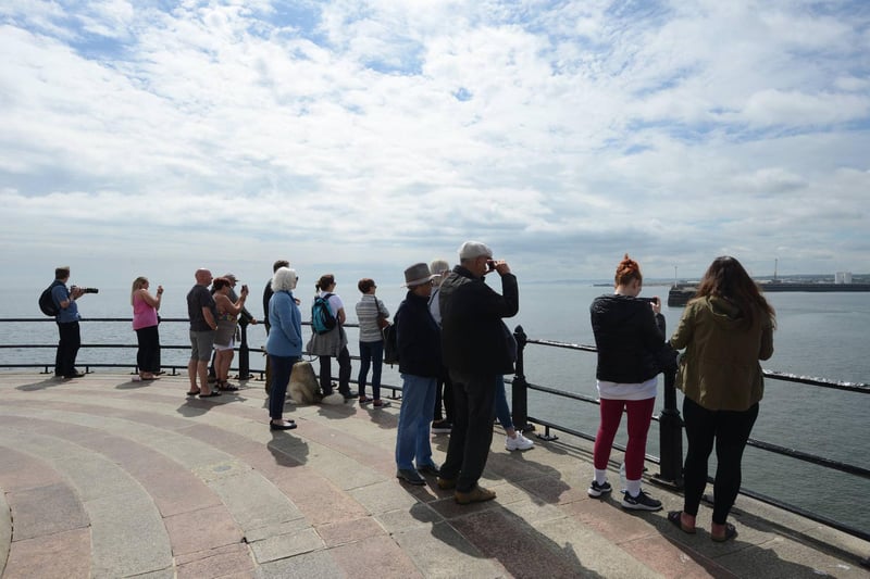 Crowds of people gathered to catch of a sighting of the marine animals. (Photo by North News)