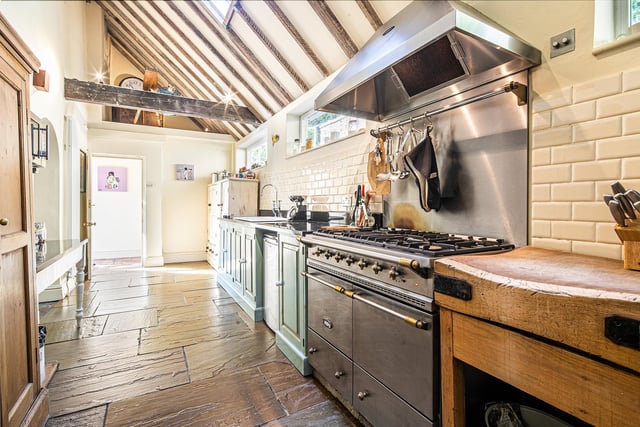 The expansive kitchen has a flagged floor - and there's room for this restaurant-worthy oven and hob.