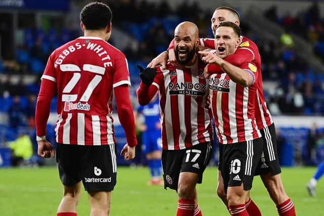 David McGoldrick of Sheffield United celebrates scoring the third goal with Billy Sharp and provider Morgan Gibbs-White during the Sky Bet Championship match at the Cardiff City Stadium, Cardiff: Ashley Crowden / Sportimage