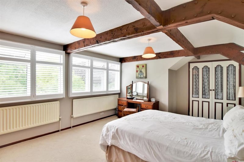 The master bedroom on the fist floor has exposed beams to ceiling, windows with plantation shutters overlooking the gardens, walk-in wardrobe and double radiators