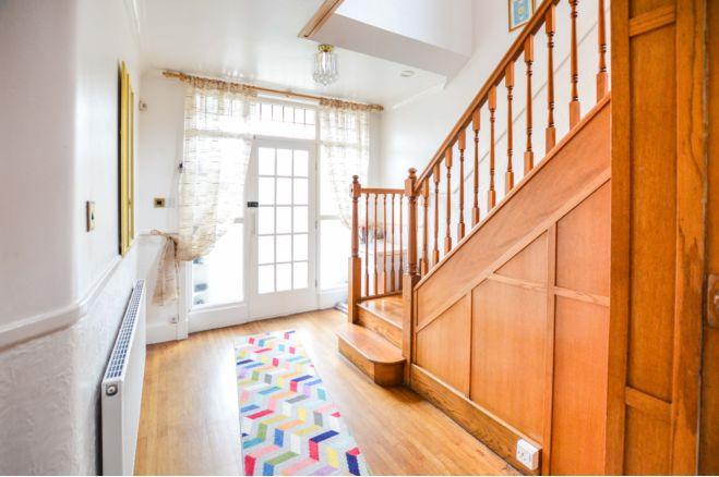 The spacious entrance hallway is described by Purplebricks as grand. It says: "A grand entrance hall with wooden balustrade and wooden flooring and stairs rising to the first floor."