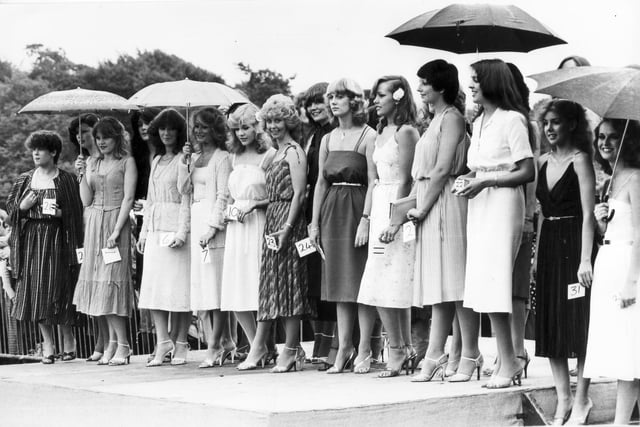 Our picture shows competitors in the Miss Motor Show contest standing in the rain at the Gala in Graves Park in July 1981