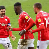 Barnsley's Daryl Dike (centre) celebrates with Alex Mowatt after scoring their side's second goal of the game during the Sky Bet Championship match at Oakwell. Isaac Parkin/PA Wire.