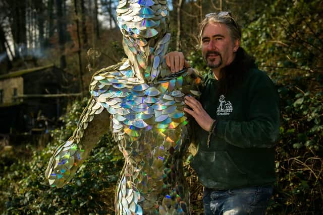 Andrew Vickers 54, built the sculpture 'Starman', at his studio in Storrs Wood by cutting up over 1,000 recycled DVDs.