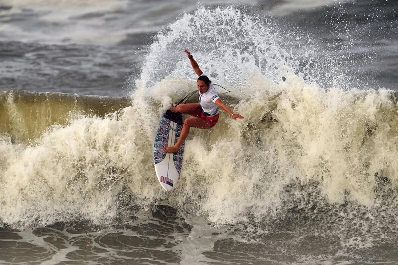 Carissa Moore, of the United States, preforms on the wave during the gold medal heat in the women's surfing competition