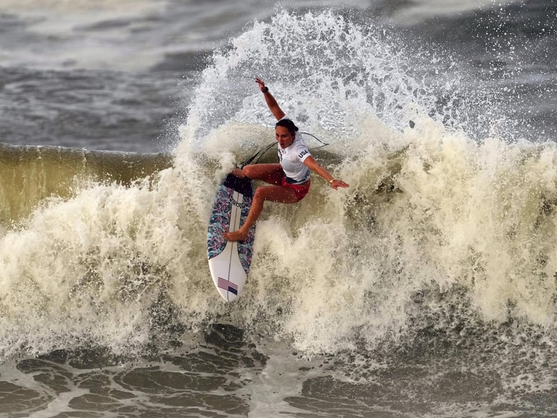 Carissa Moore, of the United States, preforms on the wave during the gold medal heat in the women's surfing competition