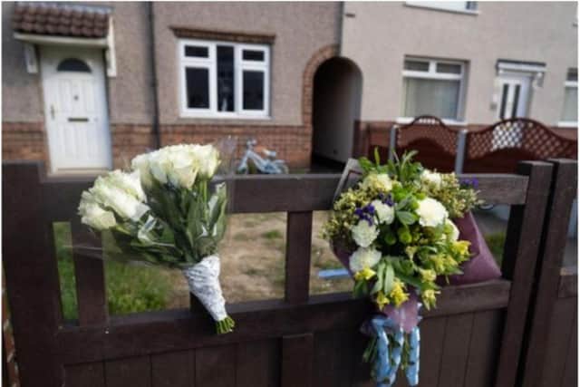 Flowers were left outside the home following the tragedy. (Photo: SWNS).