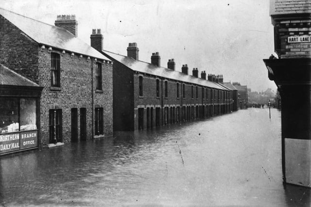 Floodwater affects the streets near Hart Lane in this scene but can anyone take a guest at the year of the photo?