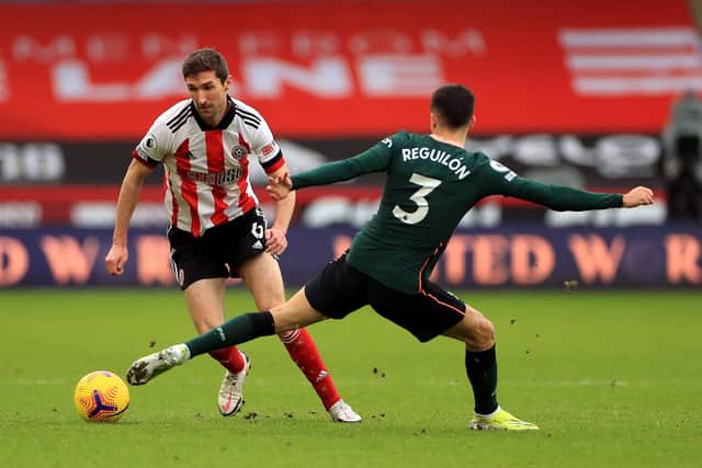 Sheffield United's Chris Basham (left) and Tottenham Hotspur's Sergio Reguilon battle for the ball during the Premier League match at Bramall Lane. Mike Egerton/PA Wire.