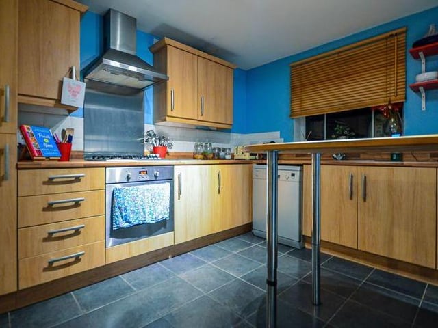 The kitchen is modern and attractive, with space for all the appliances you need, plus plenty of work and storage space.