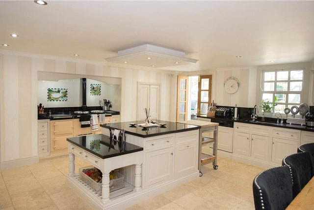 Bright and modern, the kitchen is generous in size and benefits from fitted cupboards and appliances, an Aga range cooker, and a central island.